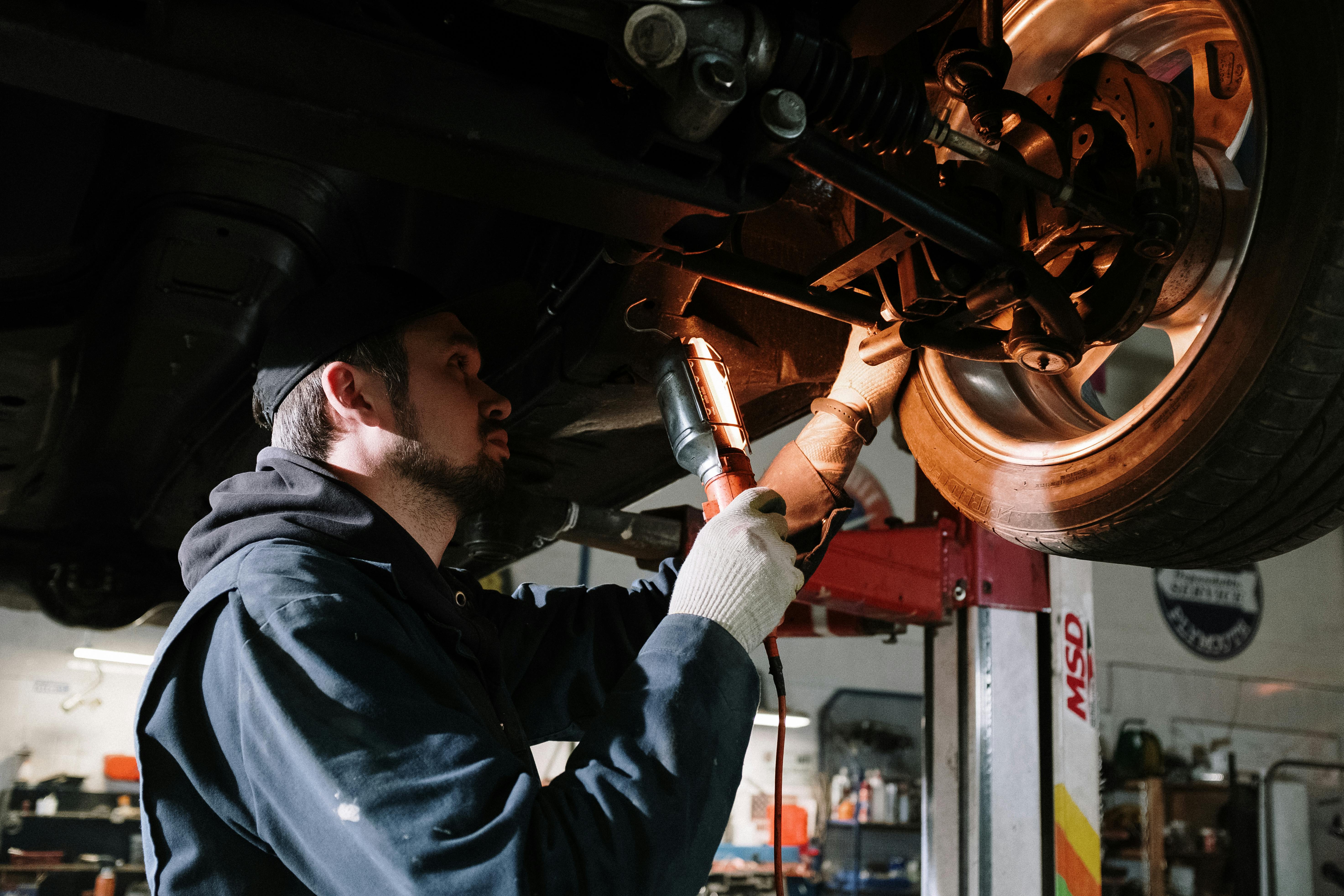 image of a mechanic looking at a tyre in a workshop